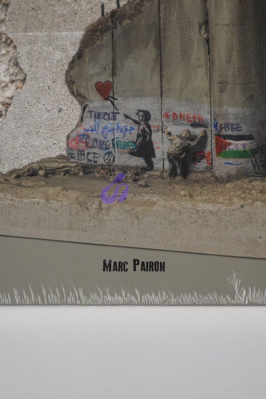 Close-up of Marc Pairon’s name on the front cover of "Banksy: The Walled Off Art Editions Are Sold Out" showing text detail.