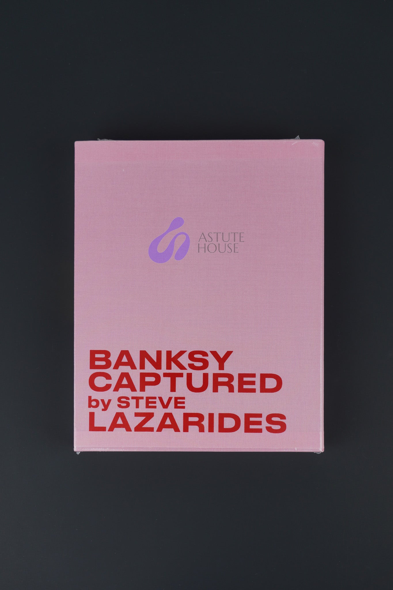 Limited edition Banksy Captured Volume 2 in a pink slipcover and hardcover design, sealed, showcasing its bold and vibrant aesthetic.