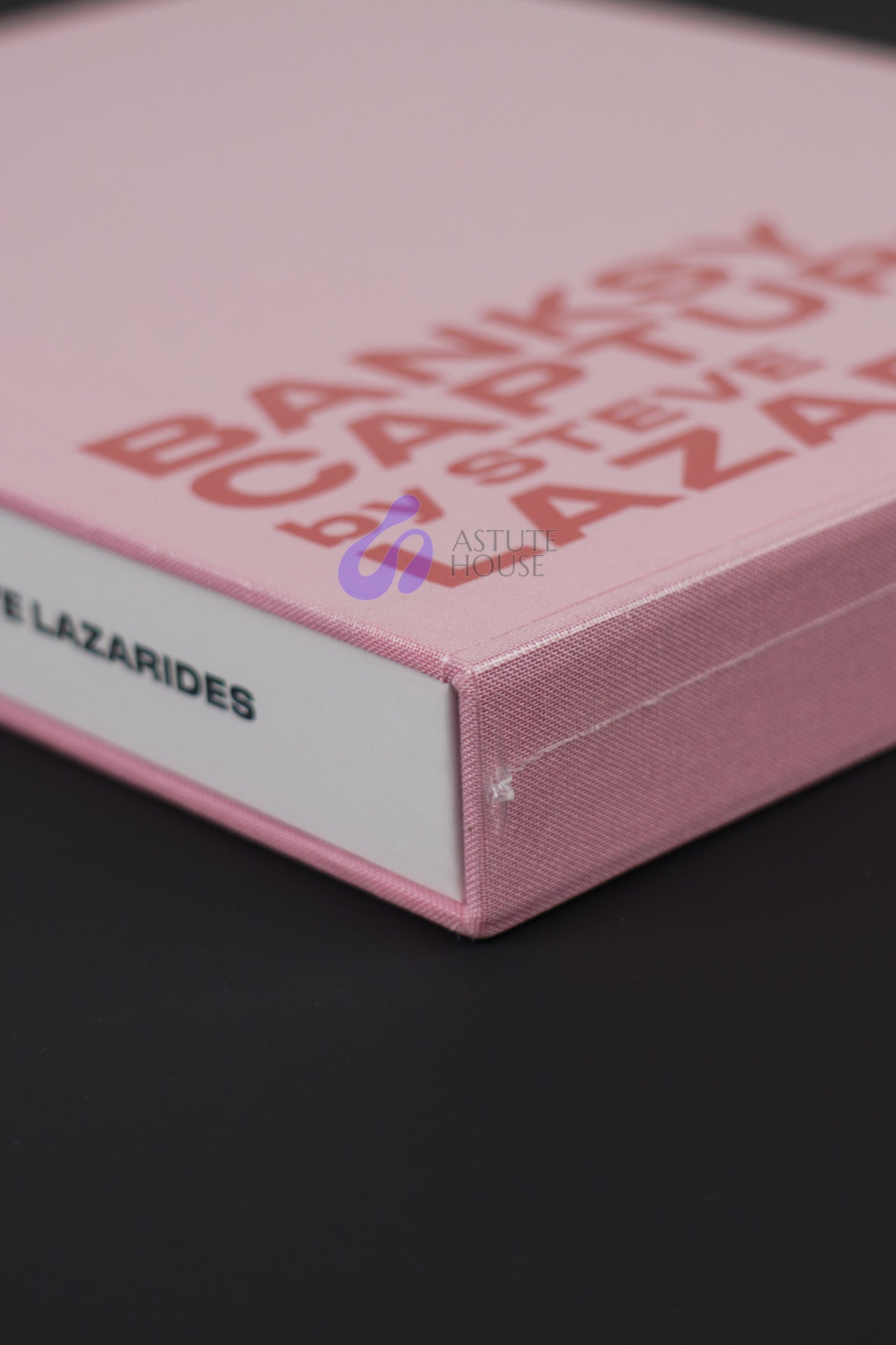 Close-up of the bottom corner of Banksy Captured Volume 2 slipcase, emphasizing its sturdy design and vibrant color.