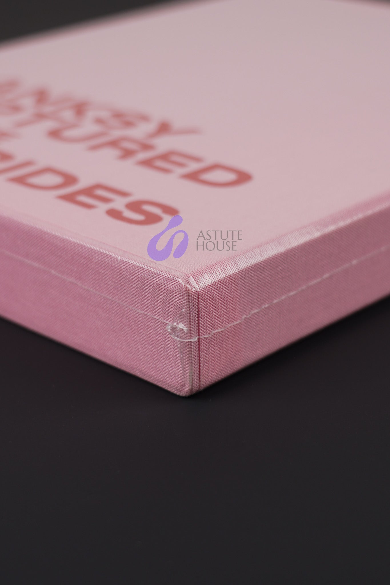 Close-up of the bottom corner of Banksy Captured Volume 2 slipcase, emphasizing its sturdy design and vibrant color.
