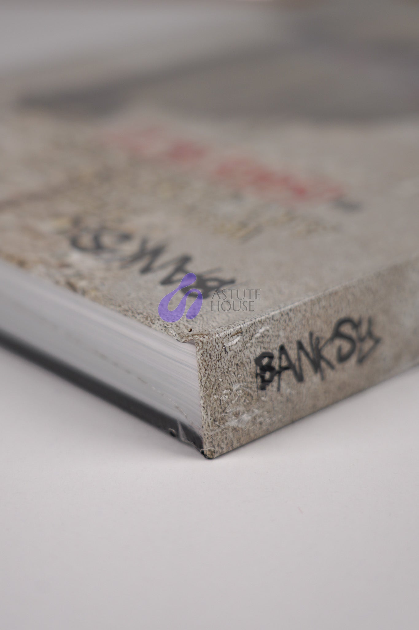 Top left corner of the front cover of "Banksy: The Walled Off Art Editions Are Sold Out" with fine detail of the book's edge.